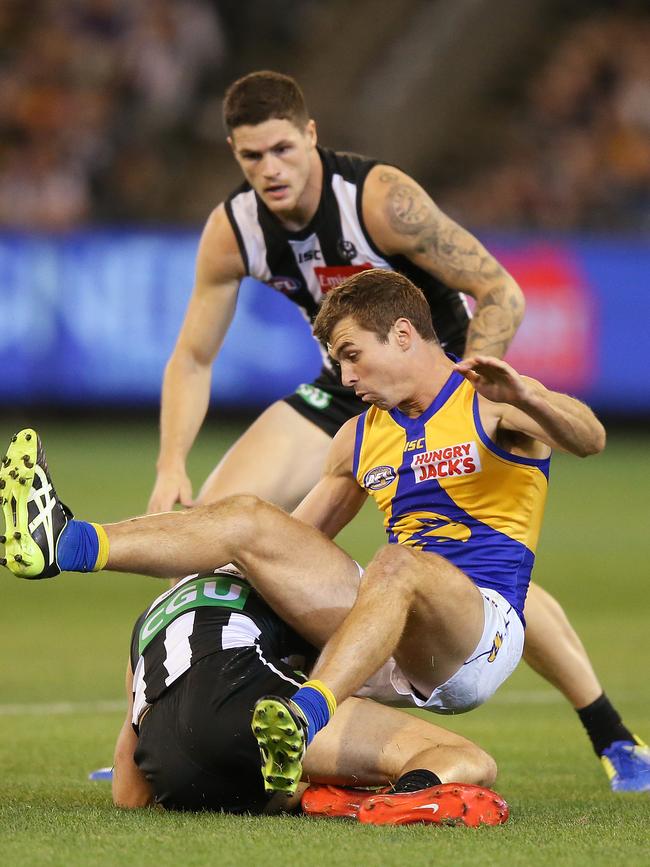 Eagles Jamie Cripps receives a free kick after Magpies Tom Phillips slides in during the round three match at Melbourne Cricket Ground. Picture: Michael Dodge/Getty