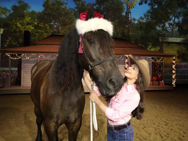 Christmas is in the air at Outback Spectacular. Sabrina Durante with Gregory the Friesian Santa Cross. Picture: Glenn Hampson.