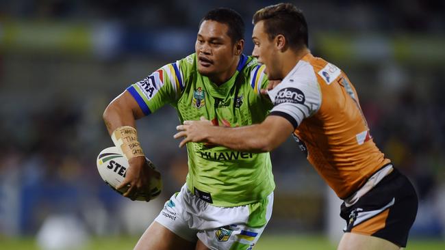 Joey Leilua of the Raiders is tackled by Luke Brooks.