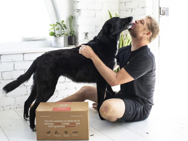 Mick Fanning with his dog Harper who is now eating Scratch, a grain free pet food. Picture: Supplied