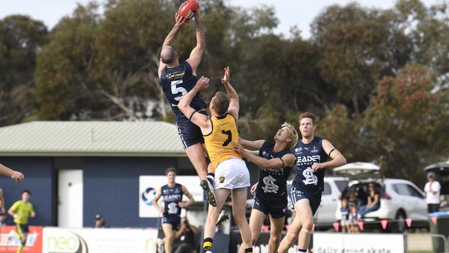 South Adelaide’s Matthew Broadbent takes a strong mark opposed to Glenelg’s Luke Reynolds at Noarlunga Oval on Sunday. Picture: Morgan Sette