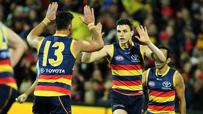 Jake Lever celebrates kicking a goal with his captain Taylor Walker. Picture: Tom Huntley