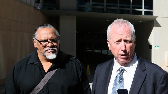 Aboriginal campaigner Adrian Burragubba with native title lawyer Colin Hardie. Picture: AAP Image/Richard Waugh