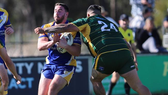 Stiff-arm madness: Windsor player Chris Leonard (No.24) takes aim at Ethan Tasoulis. Picture: Steve Montgomery