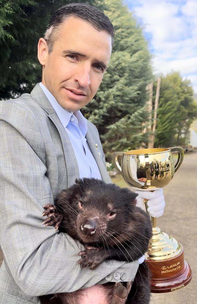 Launceston, TAS: An inquisitive wombat meets 2007 Melbourne Cup-winning jockey Michael Rodd at Tasmania Zoo. Picture: Supplied