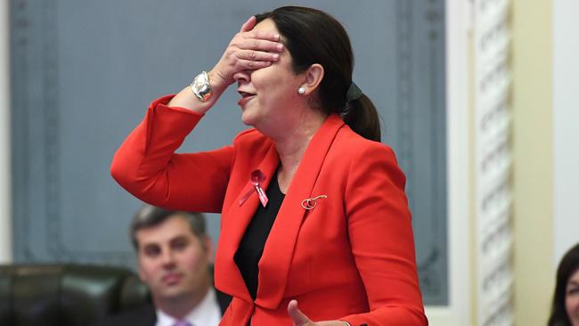 Queensland Premier Annastacia Palaszczuk covers her eyes during Question Time at Parliament House. (AAP Image/Dan Peled)