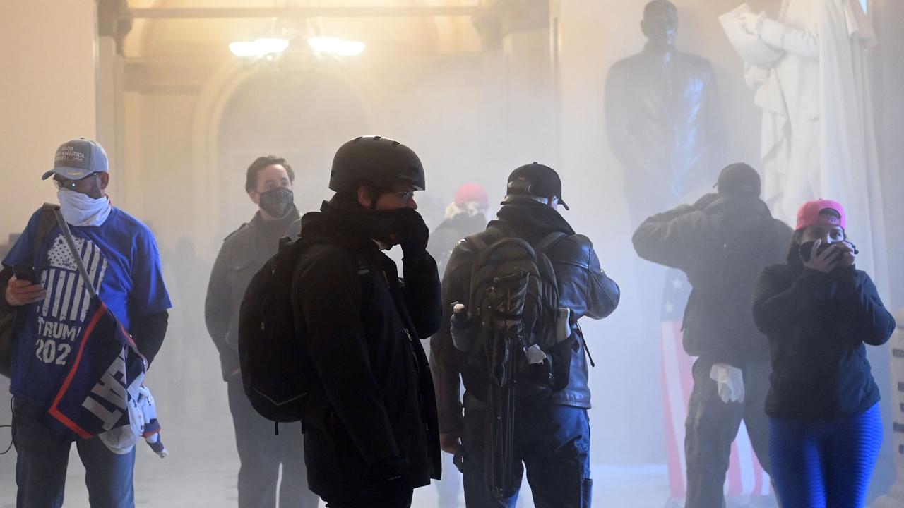 Donald Trump supporters enter the US Capitol as tear gas fills the corridor. Picture: Saul Loeb/AFP