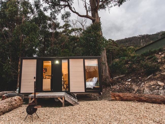 Tiny Away's newest tiny home Pirates Retreat is nestled on a hill that is surrounded by trees and overlooks the ocean at Eaglehawk Neck. Photo: Supplied by Tiny Away