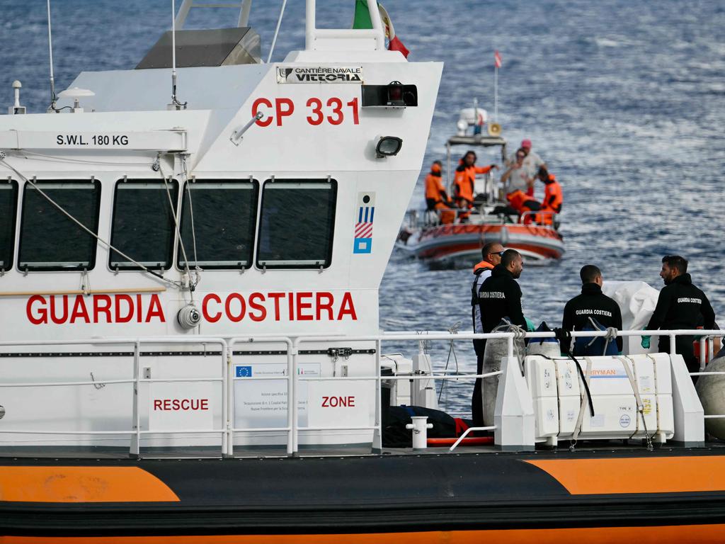 Italian Coast Guards carry a body on a rescue boat in Porticello harbour near Palermo. Picture: AFP