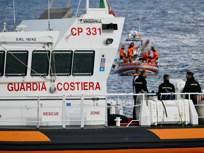 Italian Coast Guards carry a body on a rescue boat in Porticello harbour near Palermo. Picture: AFP