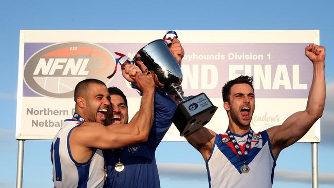 Ahmed Saad, coach Rob Maiorana and West Preston-Lakeside captain Nathan Valladares get their hands on the premiership trophy.