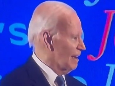 Mr Biden could be seen standing awkwardly in the back with his mouth half open.