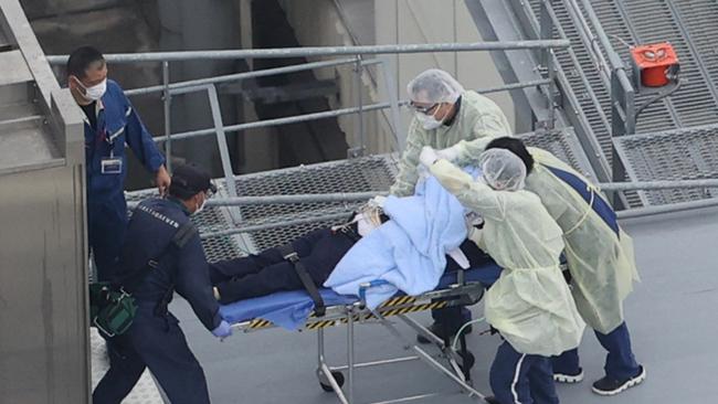 An aerial photo shows a man believed to be former Japanese Prime Minister Shinzo Abe transported to medical care. Picture: AFP