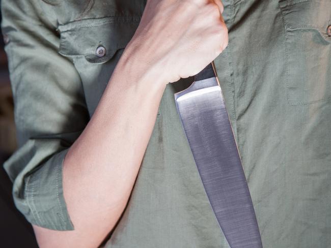 Woman holding knife generic.