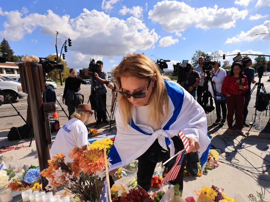 A woman places flowers at the site where a Jewish man was killed in Los Angeles. Picture: AFP