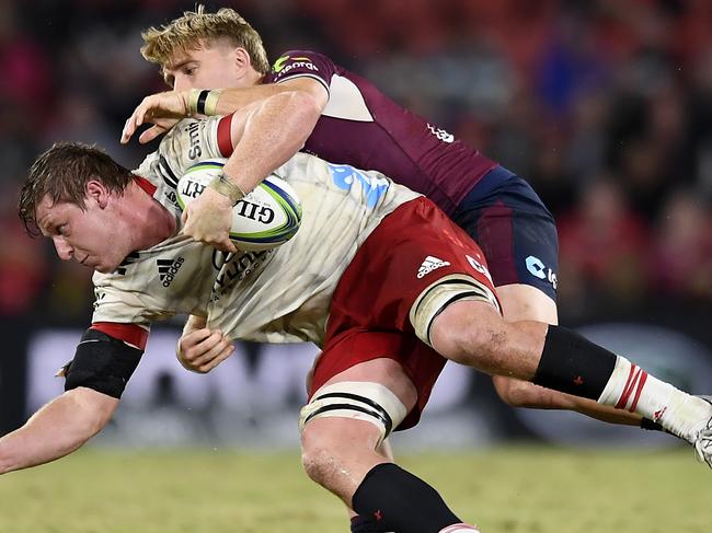 BRISBANE, AUSTRALIA - MAY 22: Cullen Grace of the Crusaders is tackled by Tate McDermott of the Reds during the round two Super Rugby Trans-Tasman match between the Queensland Reds and the Crusaders at Suncorp Stadium on May 22, 2021 in Brisbane, Australia. (Photo by Albert Perez/Getty Images)