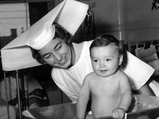 04/1962. Even little Rodney, a young patient at the Royal Children's Hospital, seems pleased with his weight as he is put on the scales by Sister Margaret Richmond.Rodney has just had an operation and he is getting the best of care until he recovers.You, too, can help the young patients by giving to The Sporting Globe-3DB- Good Friday Appeal held in aid of the hospital.[Herald 7/4/1962]Nurse. Nurses. Royal Childrens Hospital. Melbourne. (hsretro instagram 07/04/2023)