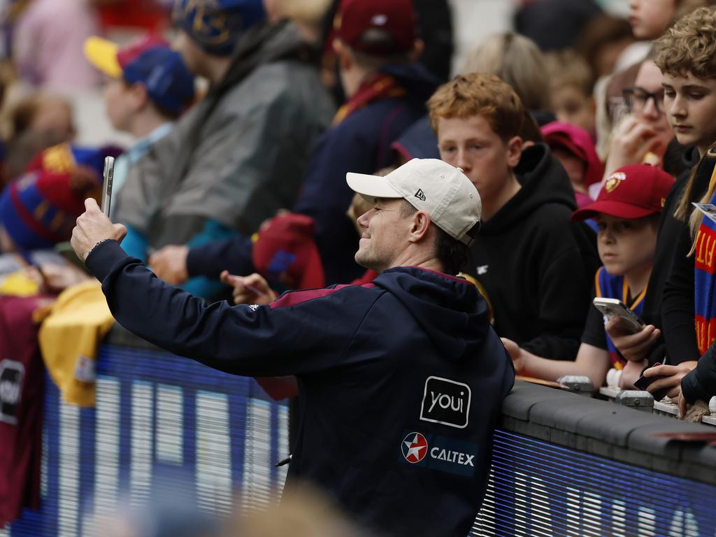 Lachie Neale takes a selfie with fans. Picture: Michael Klein