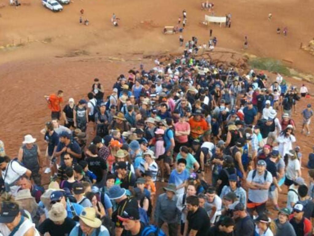 Crowds attempting to climb Uluru