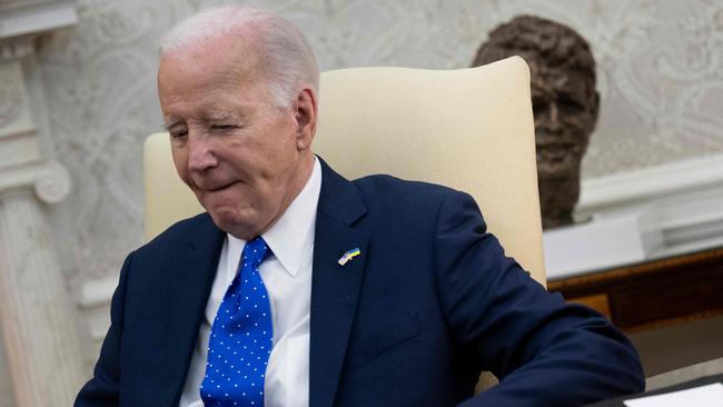 Joe Biden listens during a meeting with German Chancellor Olaf Scholz in the Oval Office of the White House on Friday. Picture: Brendan Smialowski / AFP