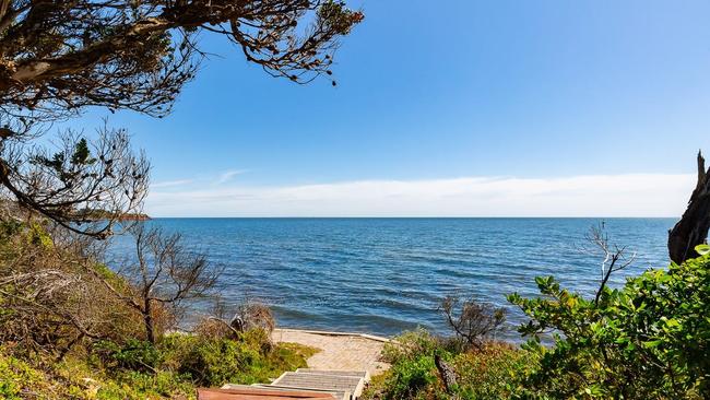 A private beach awaits at the bottom of the garden.