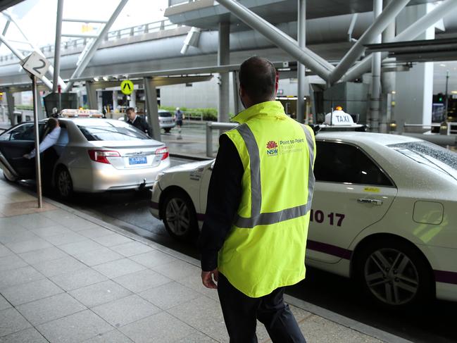 Authorised officers from the Point to Point Commission at the Sydney Airport domestic terminal this week. Picture: Tim Hunter.