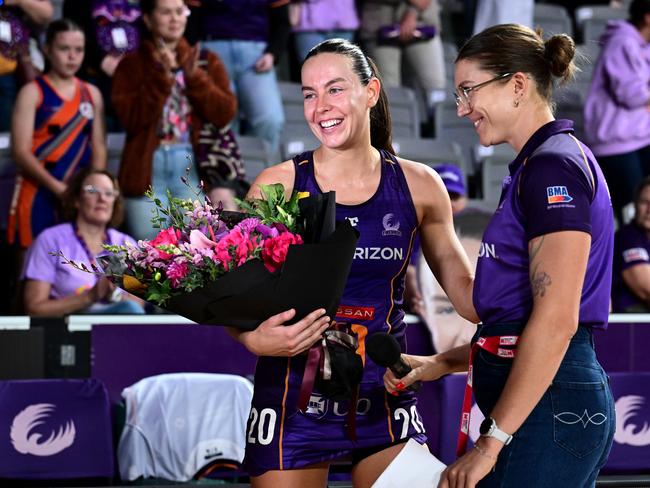 Ruby Bakewell-Doran is presented with flowers for her 50th Super Netball match. Picture: Getty Images