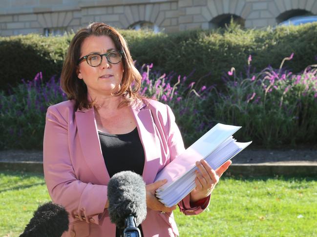 Independent MLC Meg Webb with a dossier of evidence not available to the Blake Review, as she speaks to the media on Parliament Lawns in Hobart on Wednesday, April 17, 2024.