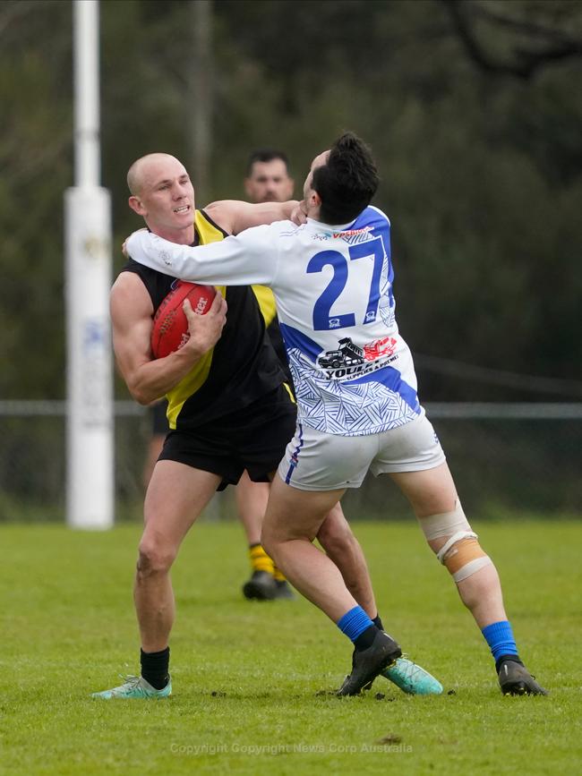 South Mornington’s Jayden Davis looks to evade a Sean Bridgen tackle. Picture: Valeriu Campan