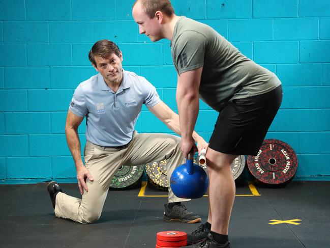 Spinal surgeon Dr David Johnson with Josh Hill, 33, who has suffered from lower back pain for years. Picture: Liam Kidston