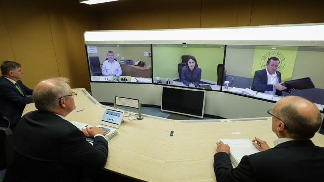 Chief Medical Officer Professor Brendan Murphy, left, Prime Minister Scott Morrison and Phil Gaetjens, right Secretary of the Department of Prime Minister and Cabinet, speak with (on screen, from left, mmebers of the national cabinet today. Picture: Alex Ellinghausen