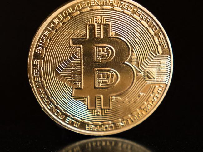 (FILES) This photo illustration shows a physical representation of a bitcoin in Hong Kong on April 16, 2024. Bitcoin's price plunged up to 5.7 percent on March 7, 2025 after US President Donald Trump signed an executive order to establish a 