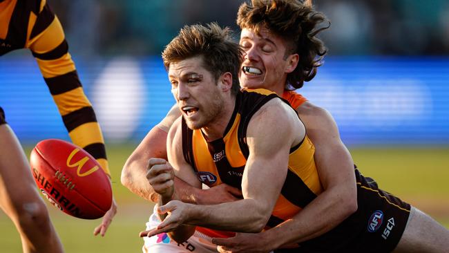 MELBOURNE, AUSTRALIA - JUNE 08: Dylan Moore of the Hawks is tackled by Toby McMullin of the Giants during the 2024 AFL Round 13 match between the Hawthorn Hawks and the GWS GIANTS at UTAS Stadium on June 08, 2024 in Launceston, Australia. (Photo by Dylan Burns/AFL Photos via Getty Images)