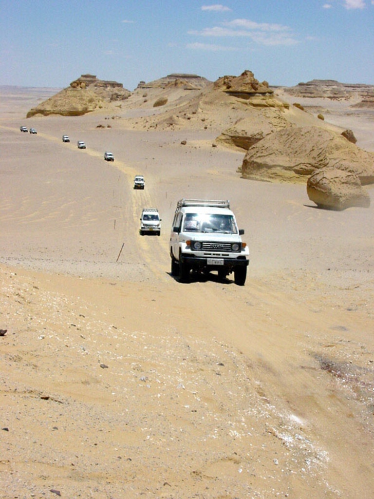 Four-wheel-drive vehicles motor cars on track in Valley of the Whales, Western Desert, Egypt. 4wd /Egypt