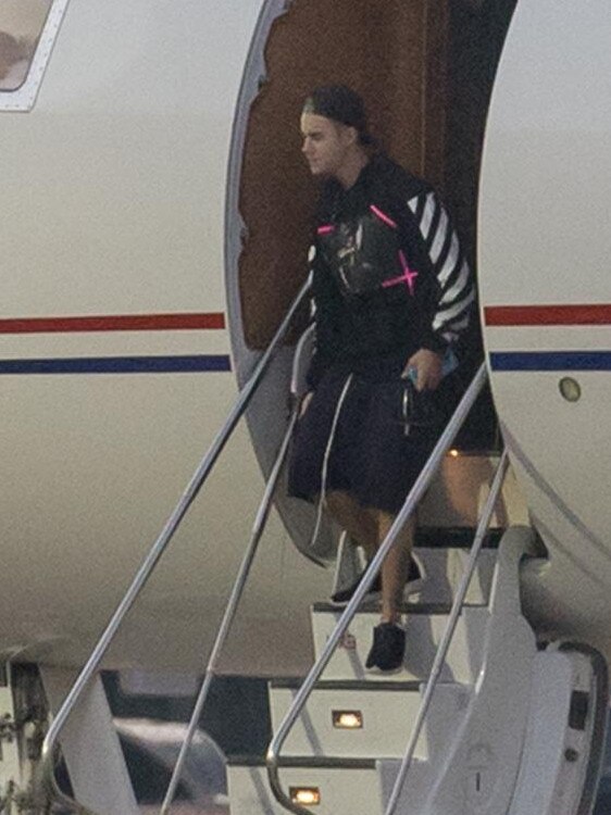 Justin Bieber disembarks in Sydney with his entourage to visit Hailey Baldwin. Picture: Splash