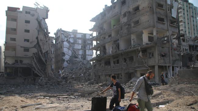 Palestinian citizens evacuate their homes damaged by Israeli air strikes on October 10, 2023 in Gaza City. Picture: Ahmad Hasaballah/Getty Images