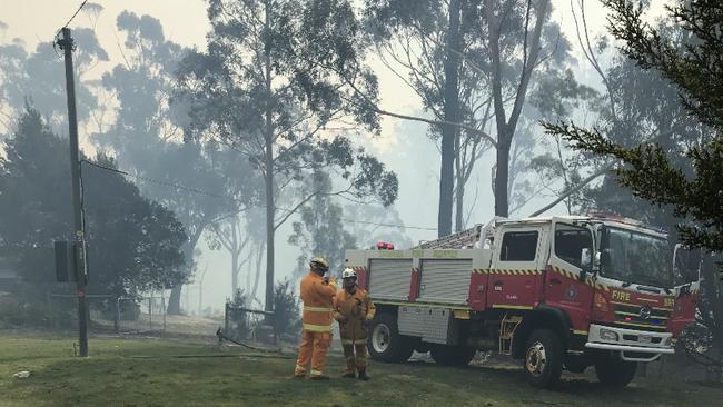 Fire and SES monitor an out of control bushfire at the top of Medeas Cove Road, St Helens.