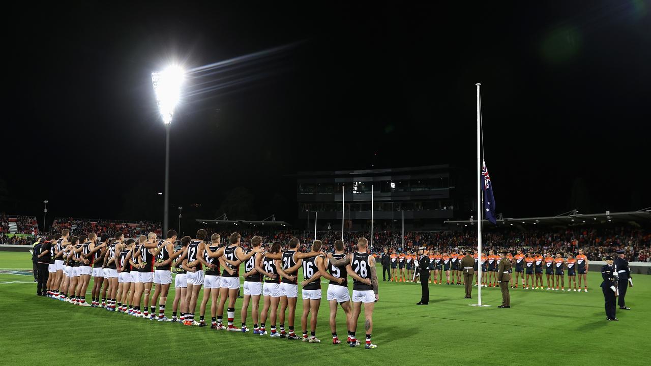 Players line up during an ANZAC Observance Ceremony at Manuka Oval. Picture: Cameron Spencer/AFL Photos/Getty Images