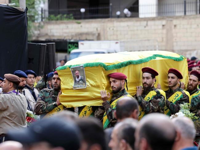 Hezbollah fighters carry the coffins of a person killed after hundreds of paging devices exploded in a deadly wave across Lebanon. Picture: AFP