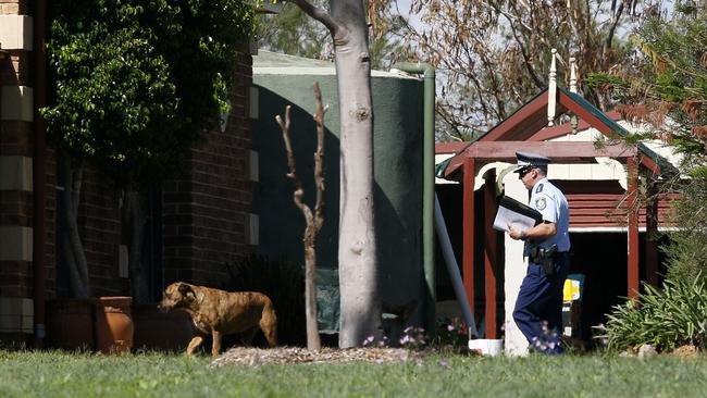 A police officer at a property in Braxton. Picture: AAP Image/Darren Pateman
