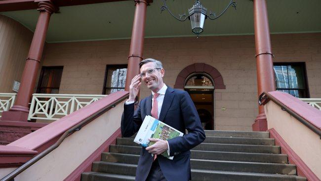 SYDNEY, AUSTRALIA - NewsWire Photos JUNE 21st, 2021: NSW Treasurer Dominic Perrottet holding the budget outside Parliament House in Sydney. Picture: NCA NewsWire / Dylan Coker