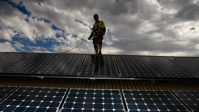 A territory worker installing Solar panels in the NT. Picture GLENN CAMPBELL