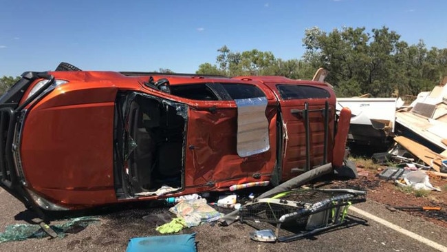 A strong gust of wind caused a car and the caravan it was towing to roll on the Stuart Highway near Elliot. Picture: NTPFES