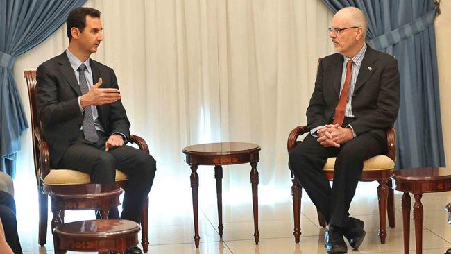 Syrian President Bashar Assad, left, meets with Australian professor Tim Anderson in Damascus, Syria, on December 23, 2013. Picture: Twitter/@Presidency_Sy