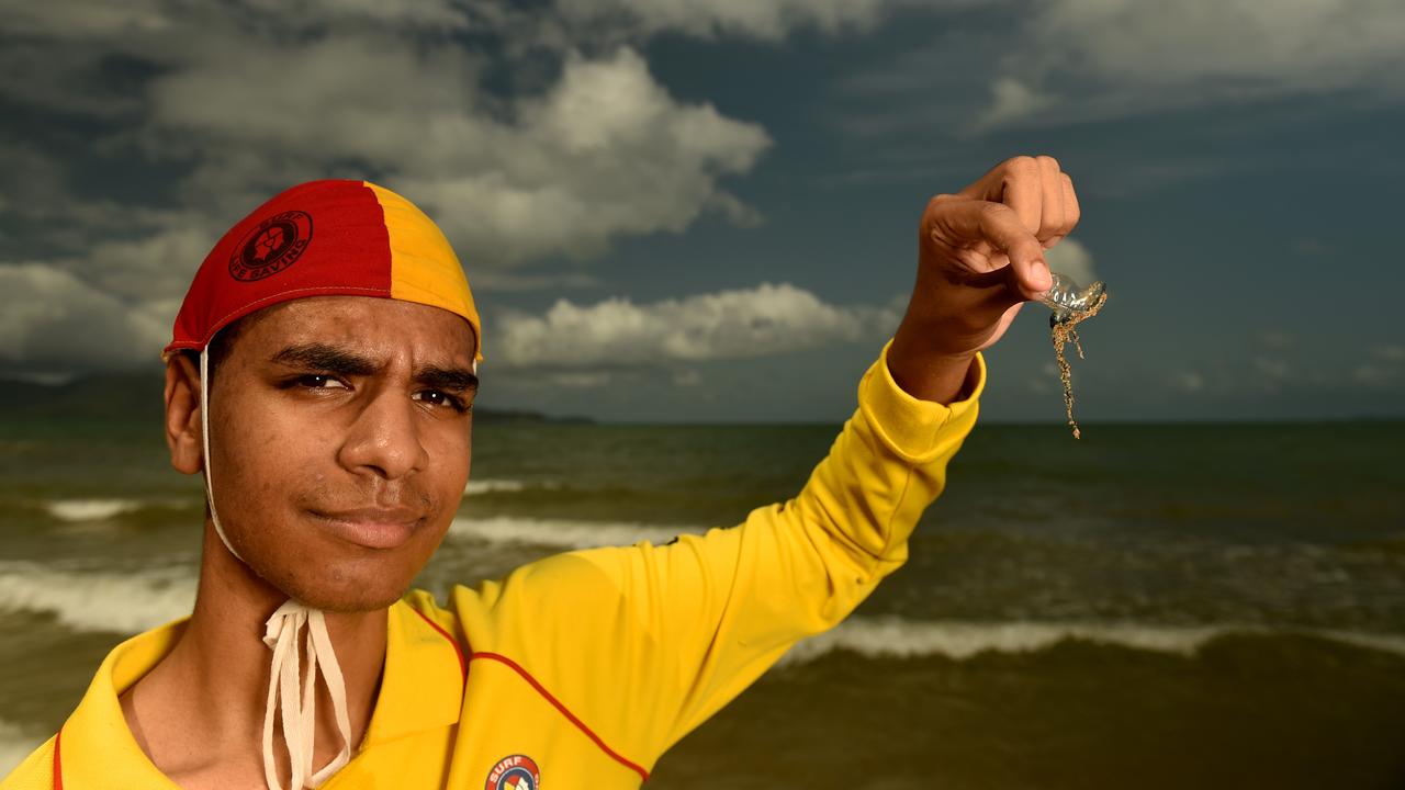 Acadian Surf Life Saving club member Jonathan Dulihanty with a small Bluebottle jellyfish on the Strand in 2020. Picture: Evan Morgan