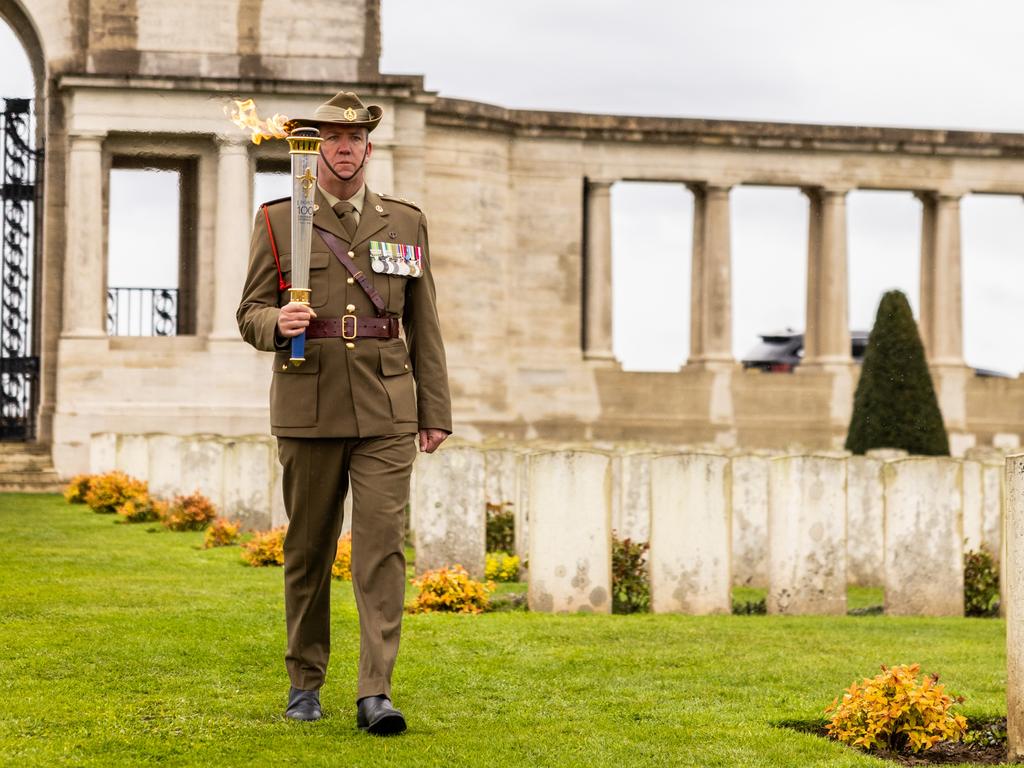 Lt Col Anthony Birch with the Legacy commemorative torch at Pozieres British Cemetery for the launch of the Legacy Centenary Torch Relay 2023, presented by Defence Health. Picture: Callum Smith