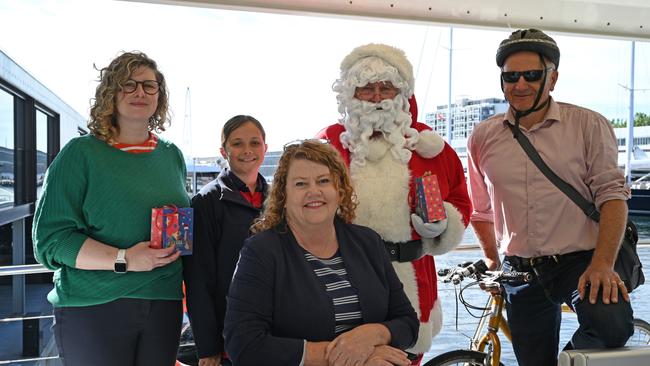 Hobart Lord Mayor Anna Reynolds with Children's Mayor Lola Mennitz, commuters Naomi Duke and Christian Narkowicz, and Santa on the ferry at Brooke Street Pier. Picture: John Sampson