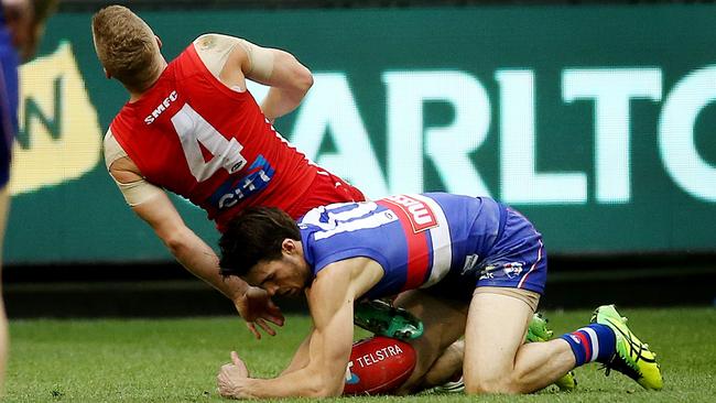 Sydney's Dan Hannebery was hurt in this tackle by Western Bulldog Easton Wood during the Grand Final.