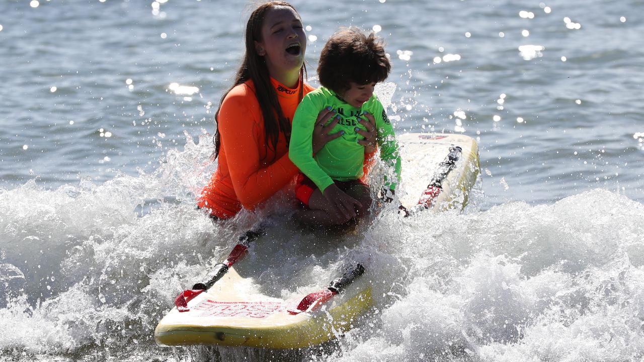 Emma Falzon and Jan Juc Surf Lifesaving Club volunteer Jess Elliott at Torquay hitting the waves for Kids Plus Foundation Surf Ed Program.Picture: Peter Ristevski