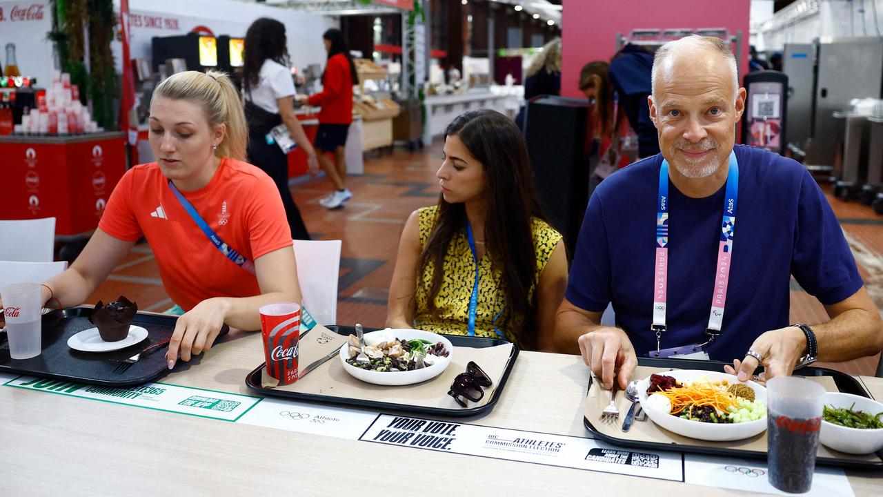 Hungary's Minister of Defense and Sport Kristof Szalay-Bobrovniczky visits Hungarian athletes at the Olympic Village. Photo by Sarah Meyssonnier / POOL / AFP